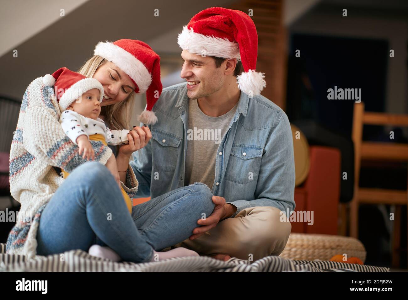Mom, Dad and baby at home on New Year's eve in a cheerful atmosphere ...