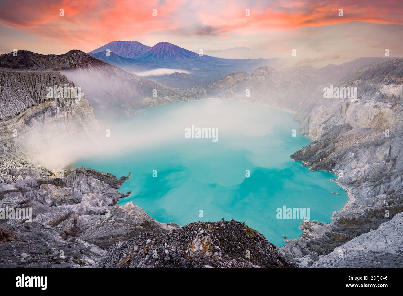 View from above, stunning aerial view of the Kawah Ijen volcano complex at sunset with the blue acid lake. Stock Photo