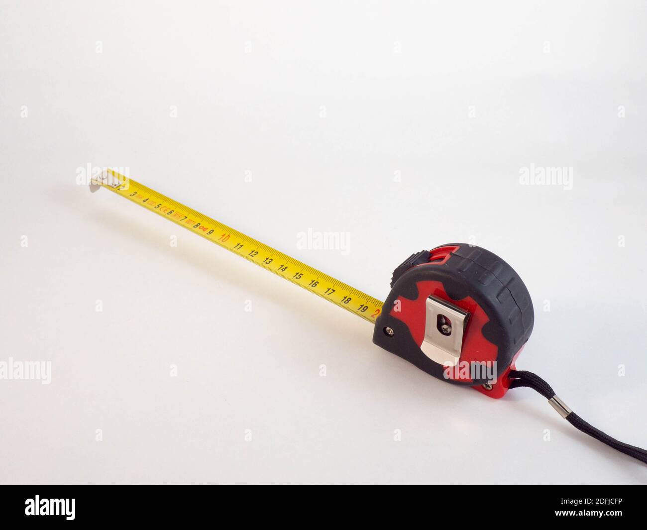 A double decimeter which is blocked on 20 centimeters, and a green ruler. Concept around works and measures. Stock Photo