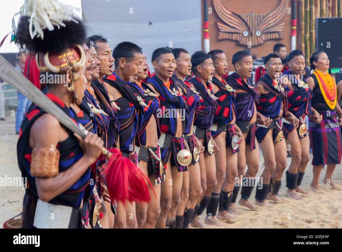 A Group Of Naga Tribesmen And Women Dressed In Their Traditional Attire Dancing During Hornbill