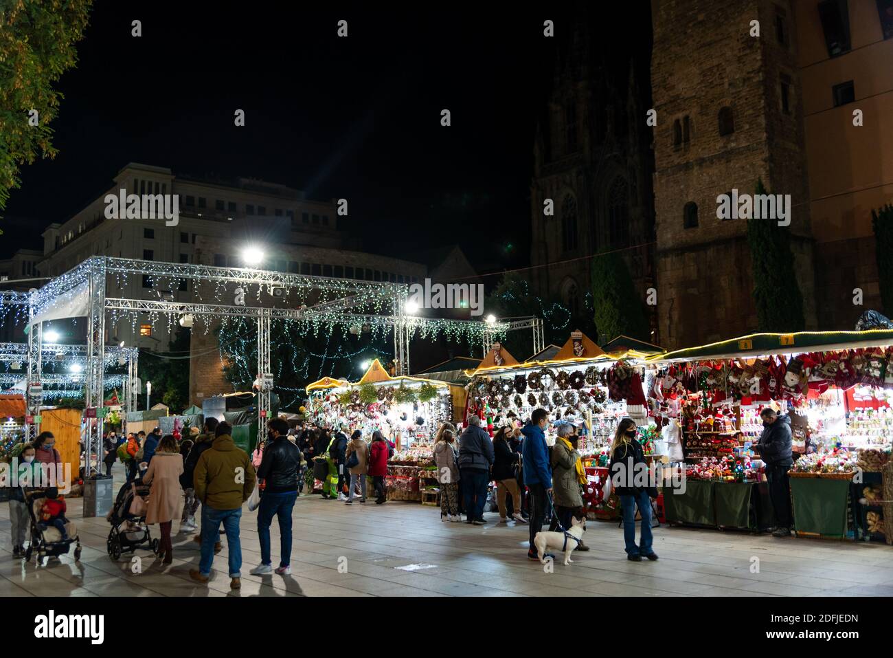 barcelona, spain - 3 december 2020: people attend christmas market in barcelona cathedral known as 'fira de santa lucia' with covid 19 restrictions on Stock Photo