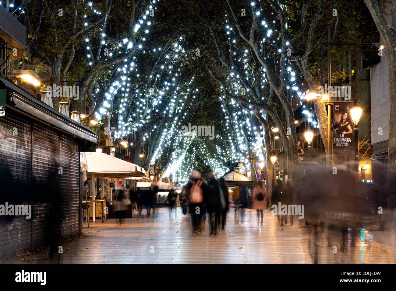 barcelona, spain - 3 december 2020: christmas time in barcelona. people walk in the city center at night doing christmas shopping with christmas light Stock Photo
