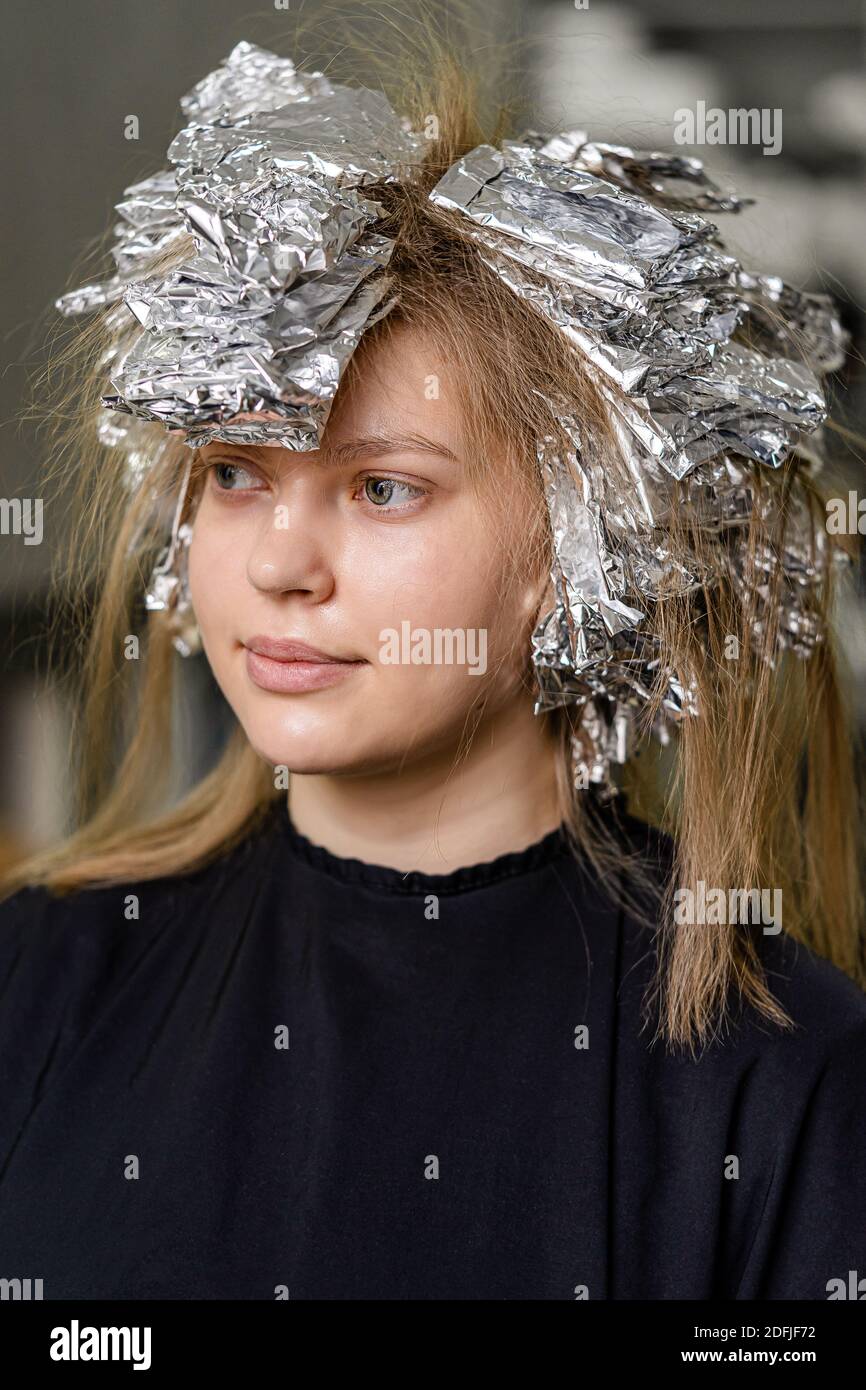 Foil on models hair. Trendy hair lightening using shatush technique