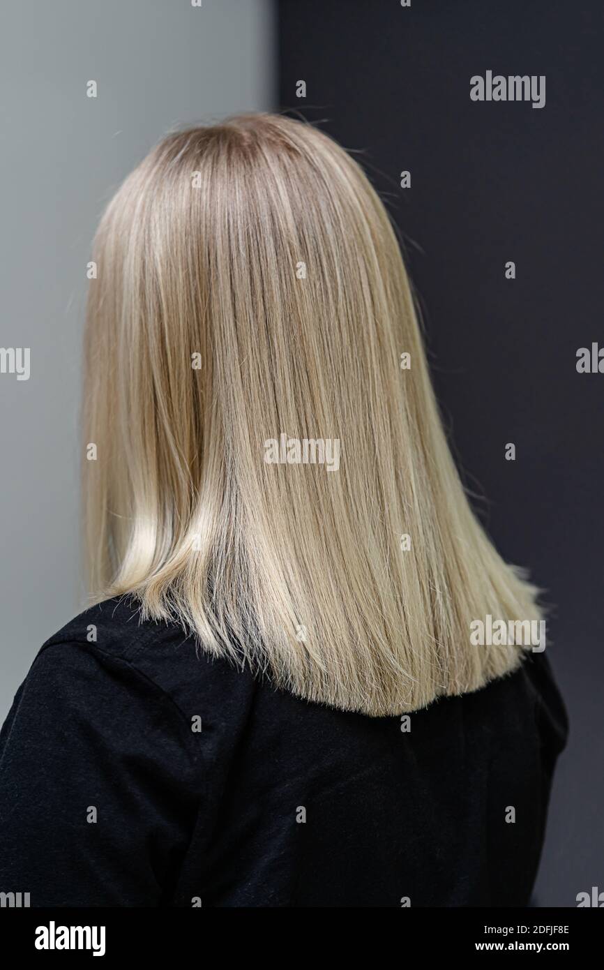 Straight hair after bleaching process. Look from behind. Hair care concept Stock Photo