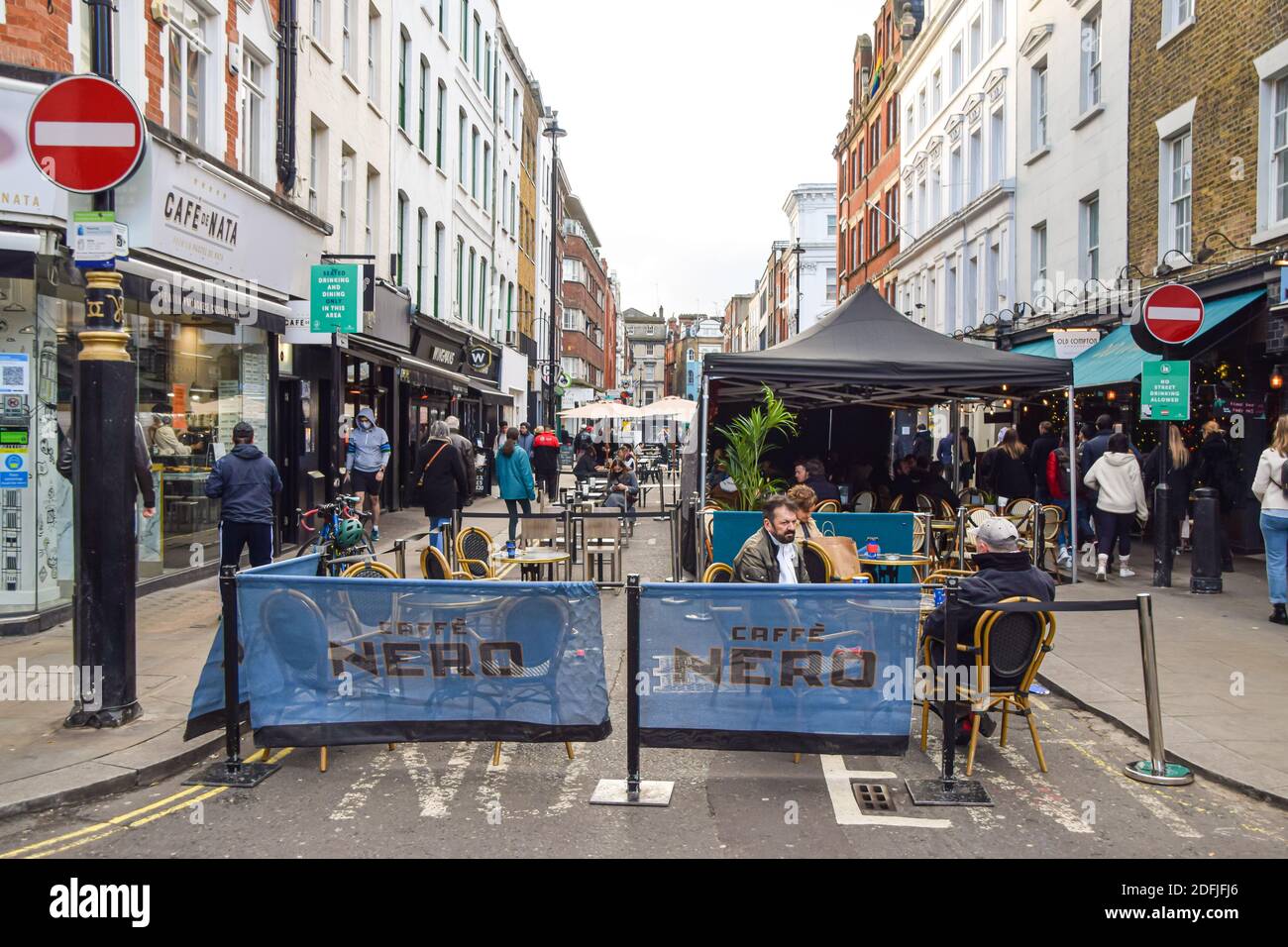 People at cafes and restaurants in Old Compton Street, Soho, London