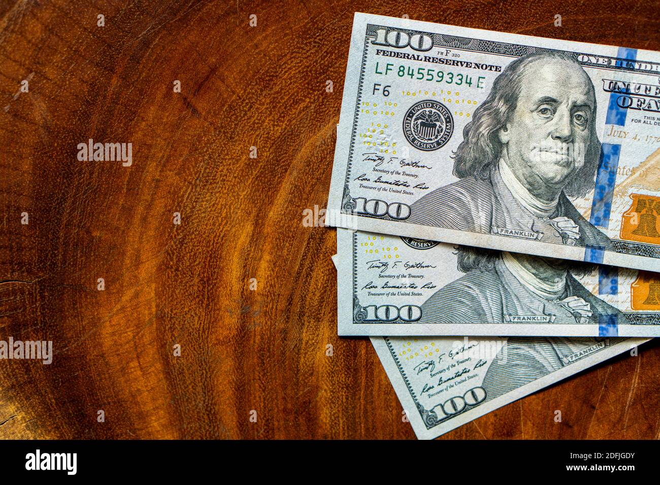 close up details of 100 dollar bill on wooden board Stock Photo - Alamy