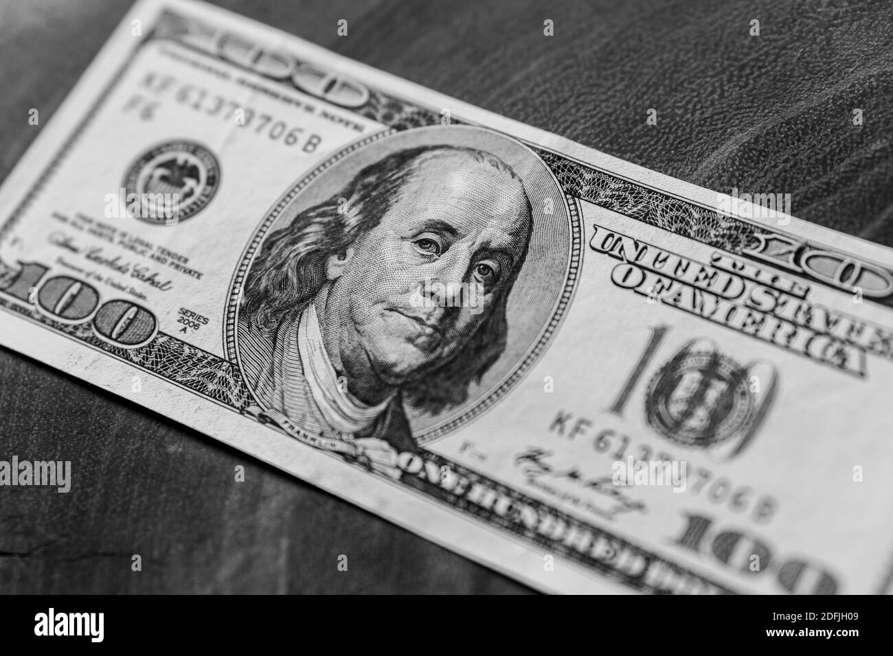 close up details of 100 dollar bill on wooden board Stock Photo