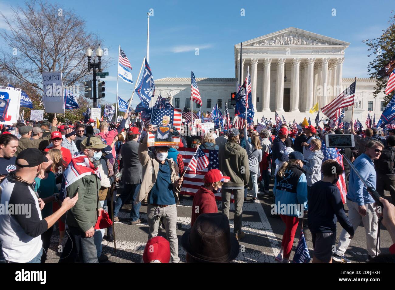 WASHINGTON, DC - NOV. 14, 2020: Trump supporters arrive at the Supreme Court after marching from a rally at Freedom Plaza in support of President Donald Trump, who refuses to concede the election. Event was organized by 'Women for America First,' 'Stop the Steal' and the 'Million MAGA March.' Stock Photo