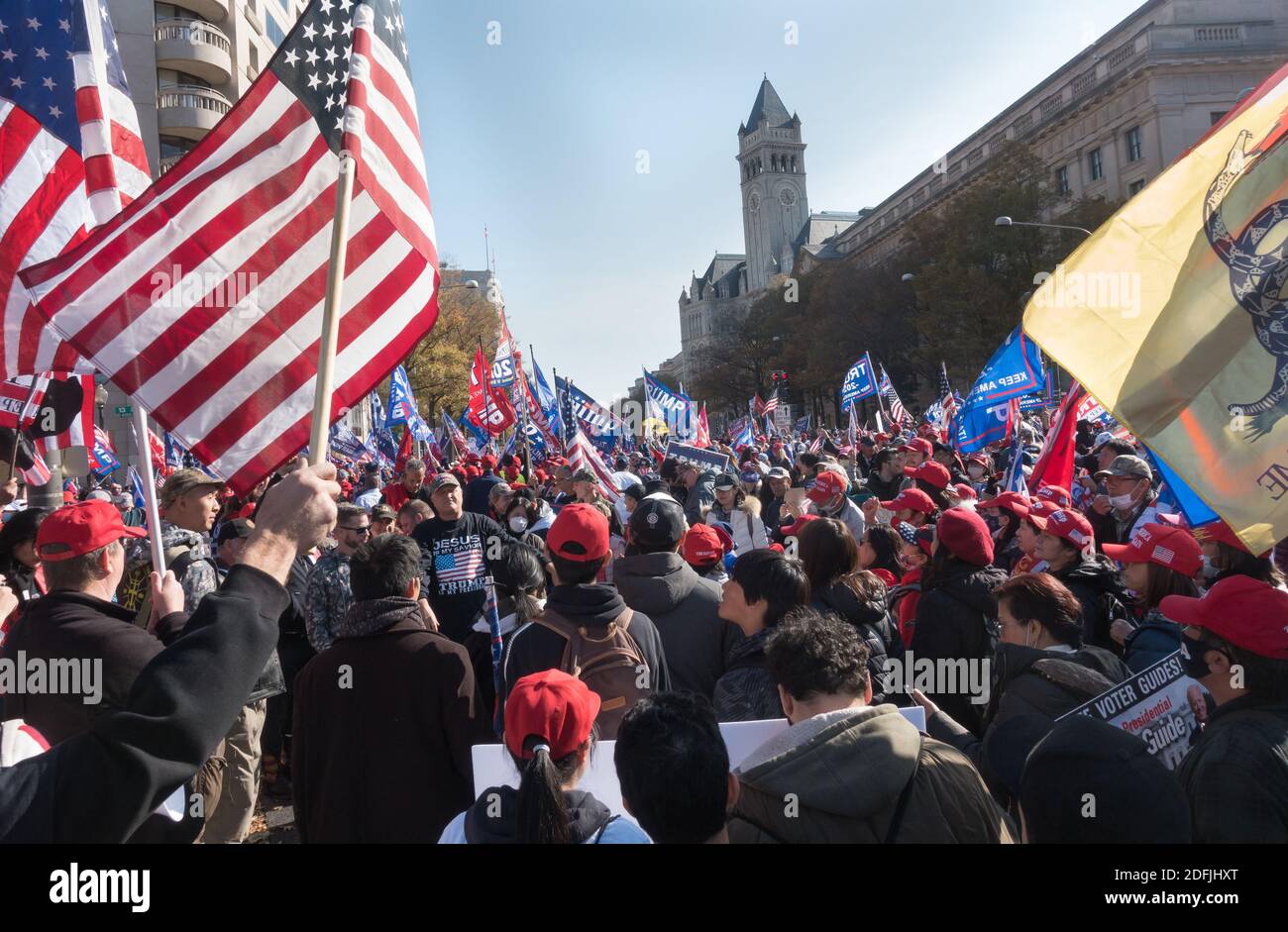 WASHINGTON, DC - NOV. 14, 2020: With Trump hotel in background, Trump supporters at Freedom Plaza rally in support of President Donald Trump, who refuses to concede the election. Event was organized by 'Women for America First,' 'Stop the Steal' and the 'Million MAGA March.' Stock Photo