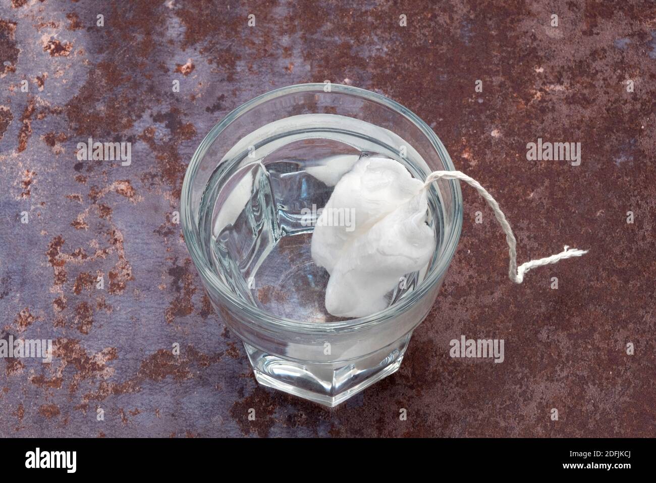 A new tampon immersed in a glass of water to demonstrate its effectiveness  Stock Photo - Alamy
