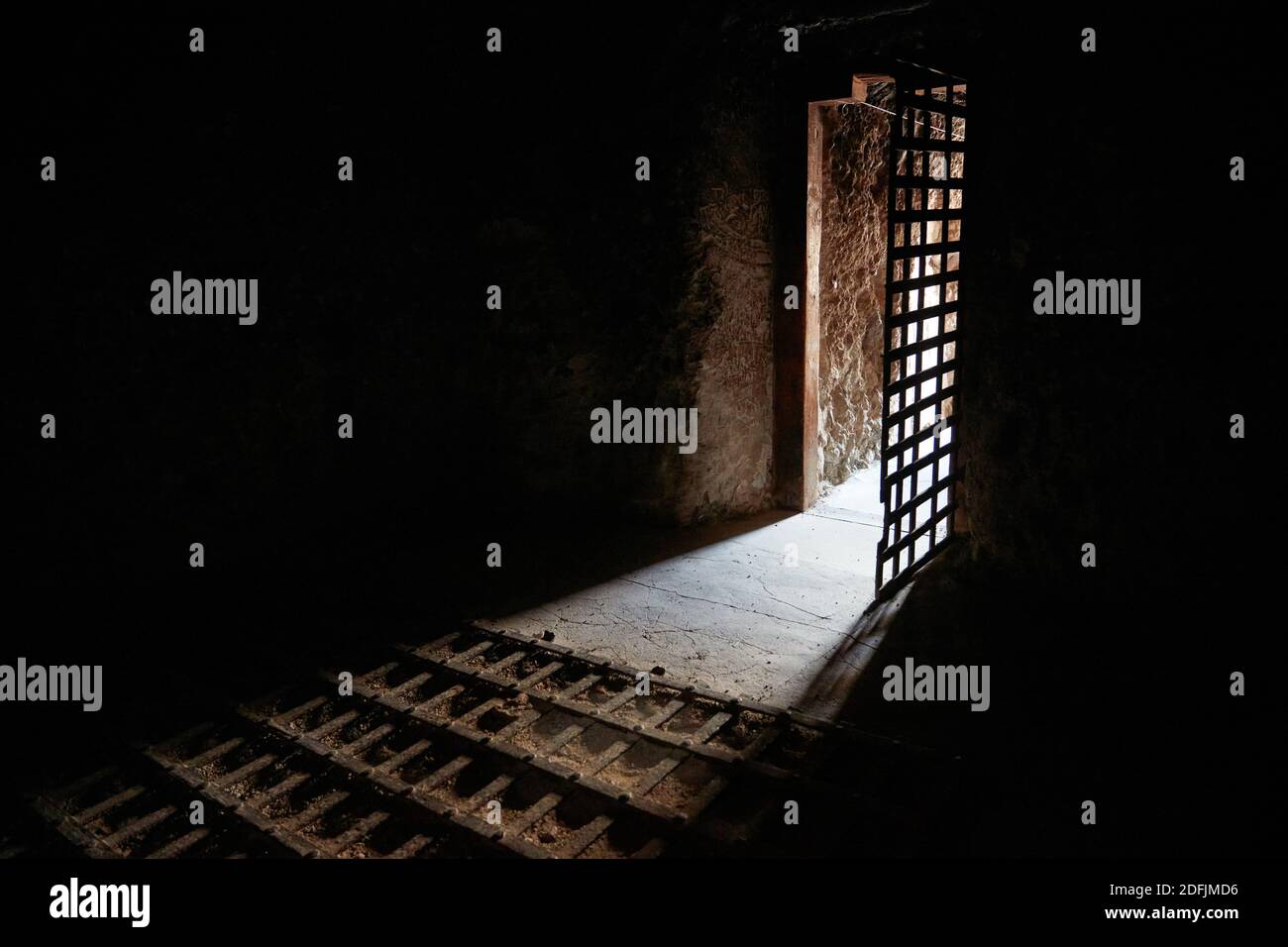 Light shining through the doorway in a solitary confinement cell in Yuma territorial prison, Yuma, Arizona Stock Photo