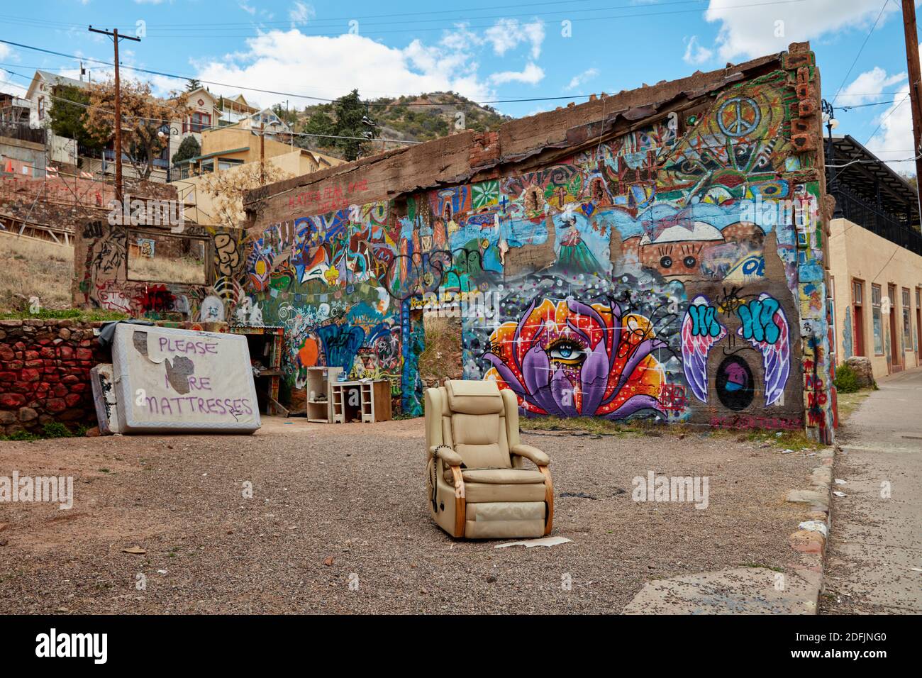 Discarded chair sitting in a vacat lot that has been turned into an area for graffiti artists in Bisbee, Arizona Stock Photo