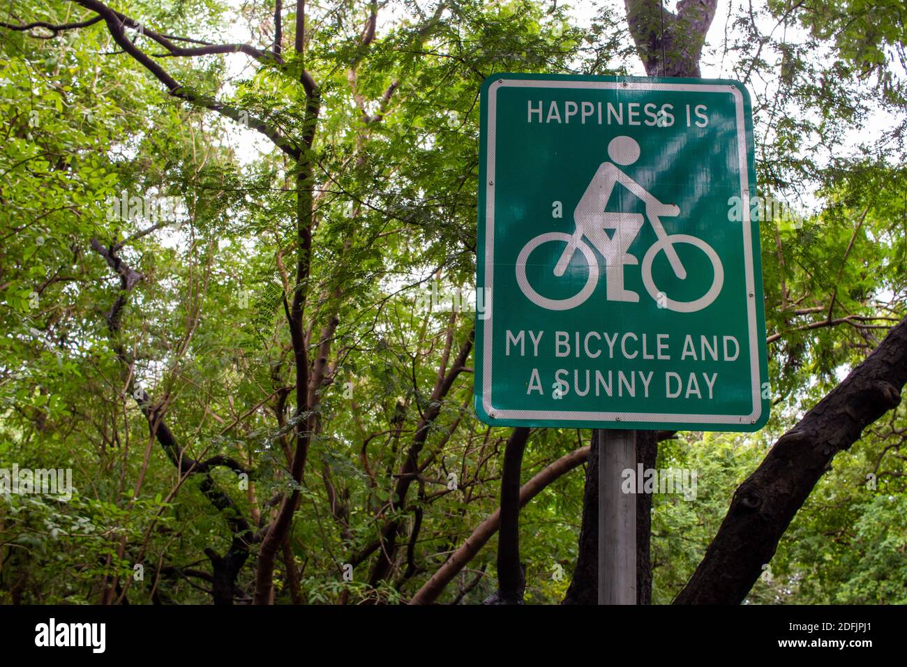 Signpost for using bicycle which is environmentally friendly mode of transportation. Encouragement for people to use bicycles. Reduce carbon footprint Stock Photo