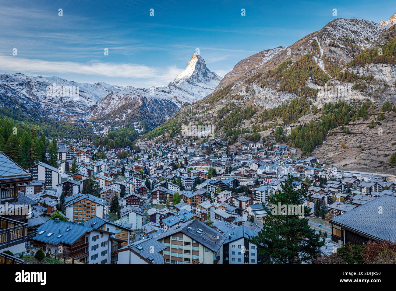 The Swiss village of Zermatt in Valais in autumn at sunrise, with the Matterhorn and the Alpine mountain range in the background. Stock Photo