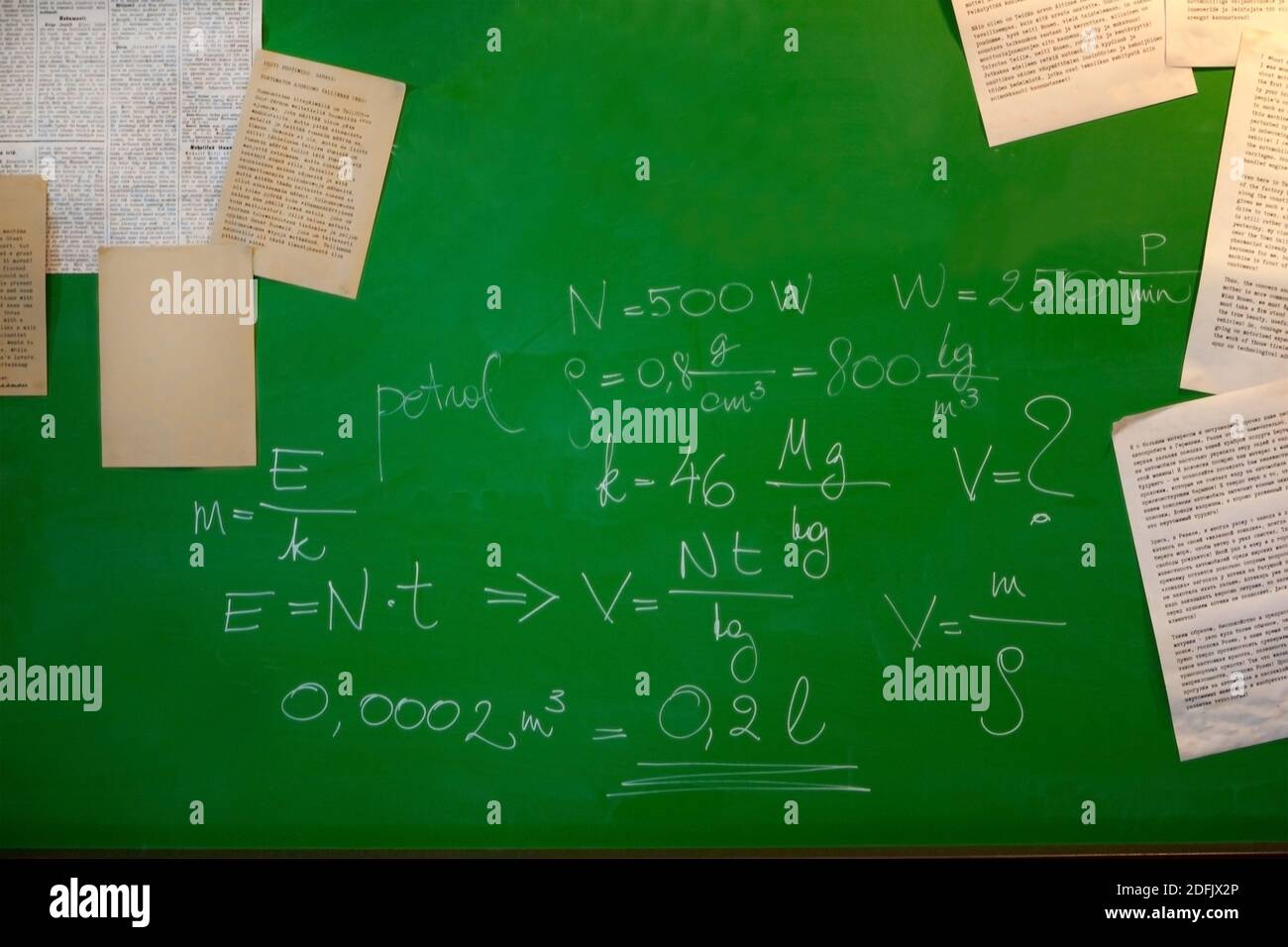 math formulas and papers on a green board - blackboard and school concept Stock Photo