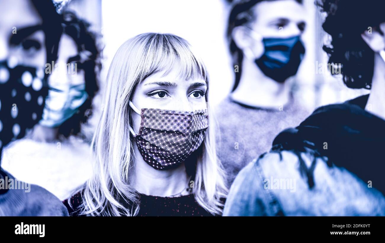 Urban commuter crowd of people moving on city street covered by face mask - New normal society concept with citizens on worried anxiety mood outdors Stock Photo