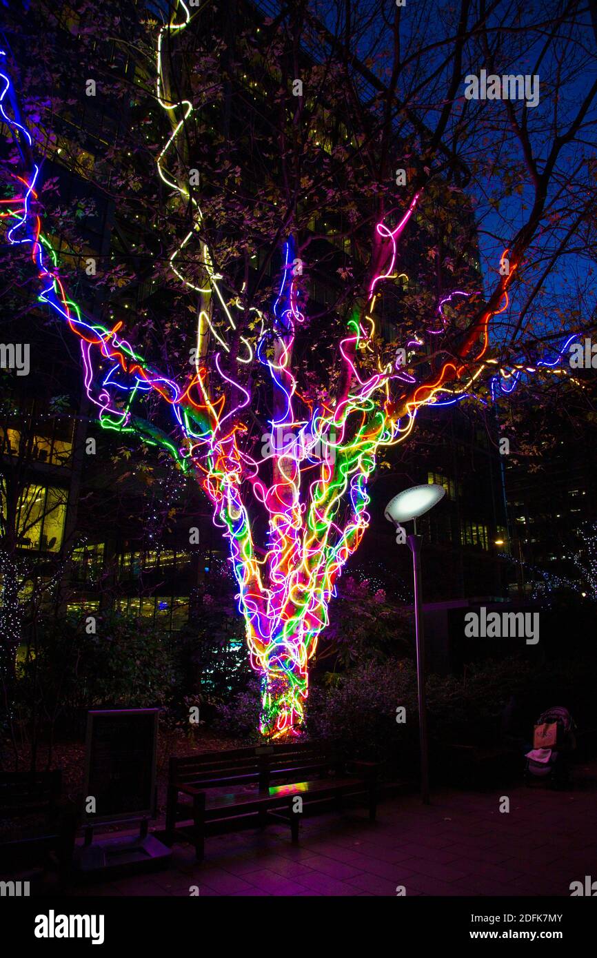 5 December 2020 - London, UK, Connected by Light curated light art installations on display, Neon Tree by Hawthorn in Canary Wharf Stock Photo
