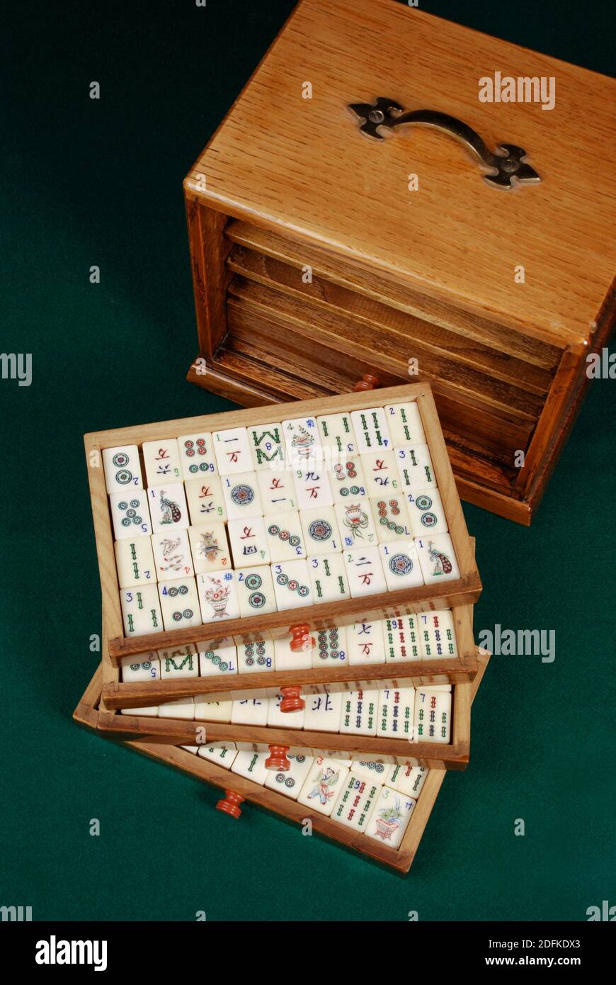 Mah-Jong, the chinese board game. The tiles are stored in trays in this wooden box set.d Stock Photo