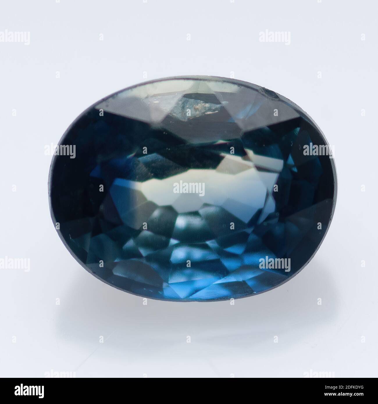 Natural blue sapphire on a white background Stock Photo