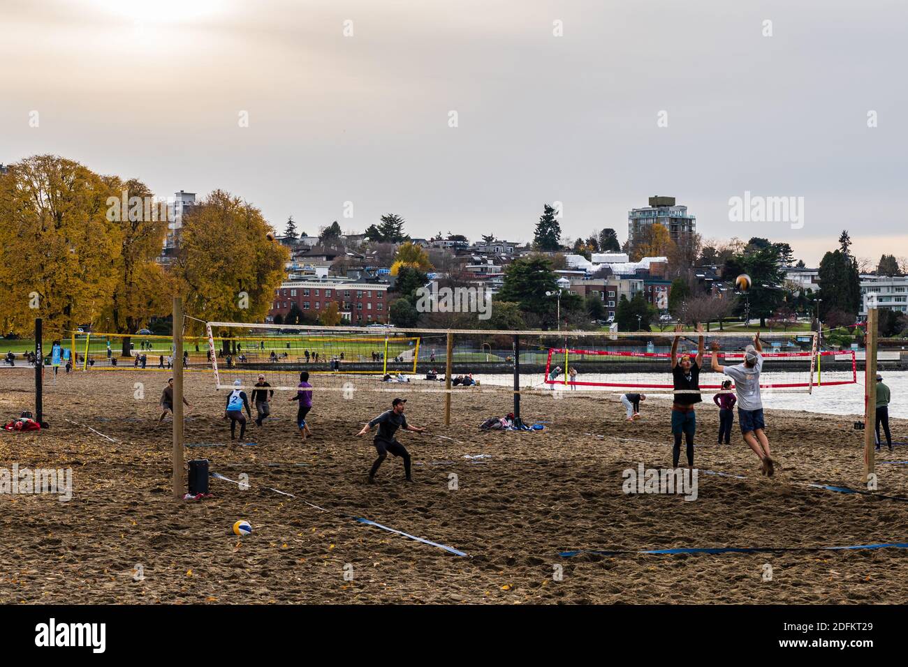 VANCOUVER, CANADA - NOVEMBER 21, 2020: people playing beach volleyball in kitsilano autumn day. Stock Photo