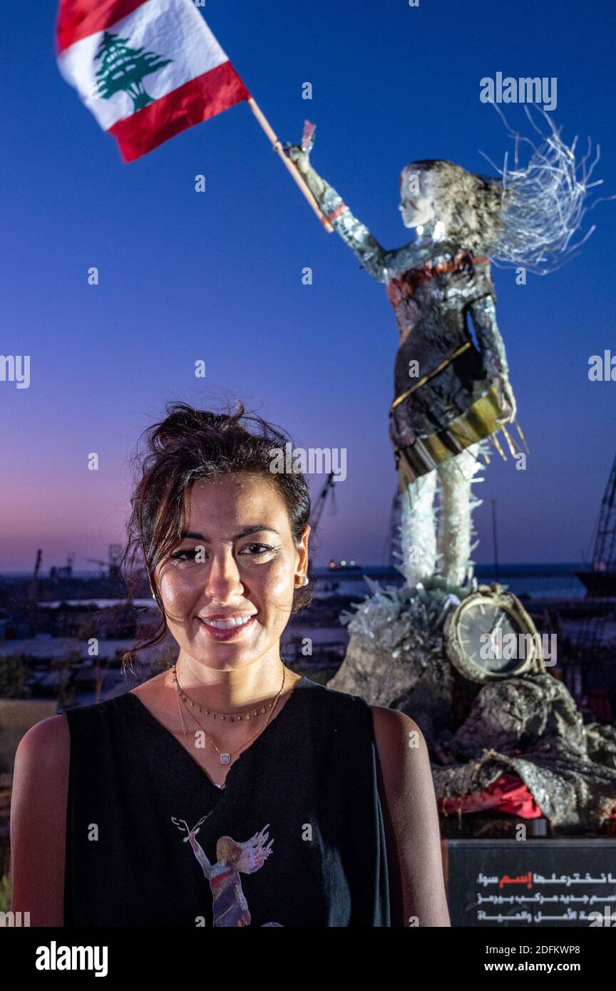 Lebanese artist and activist Hayat Nazer poses next to her sculpture