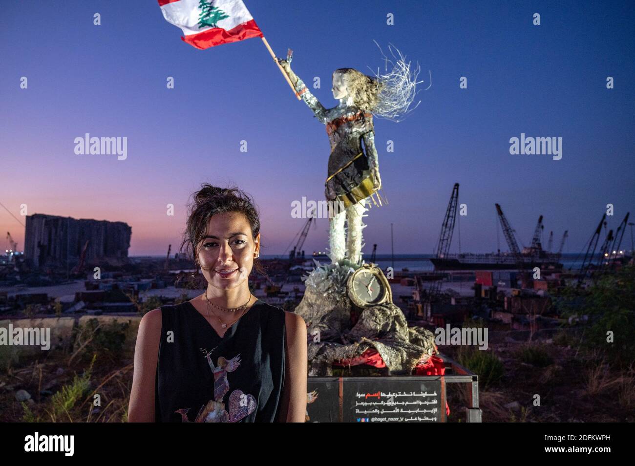 Lebanese artist and activist Hayat Nazer poses next to her sculpture
