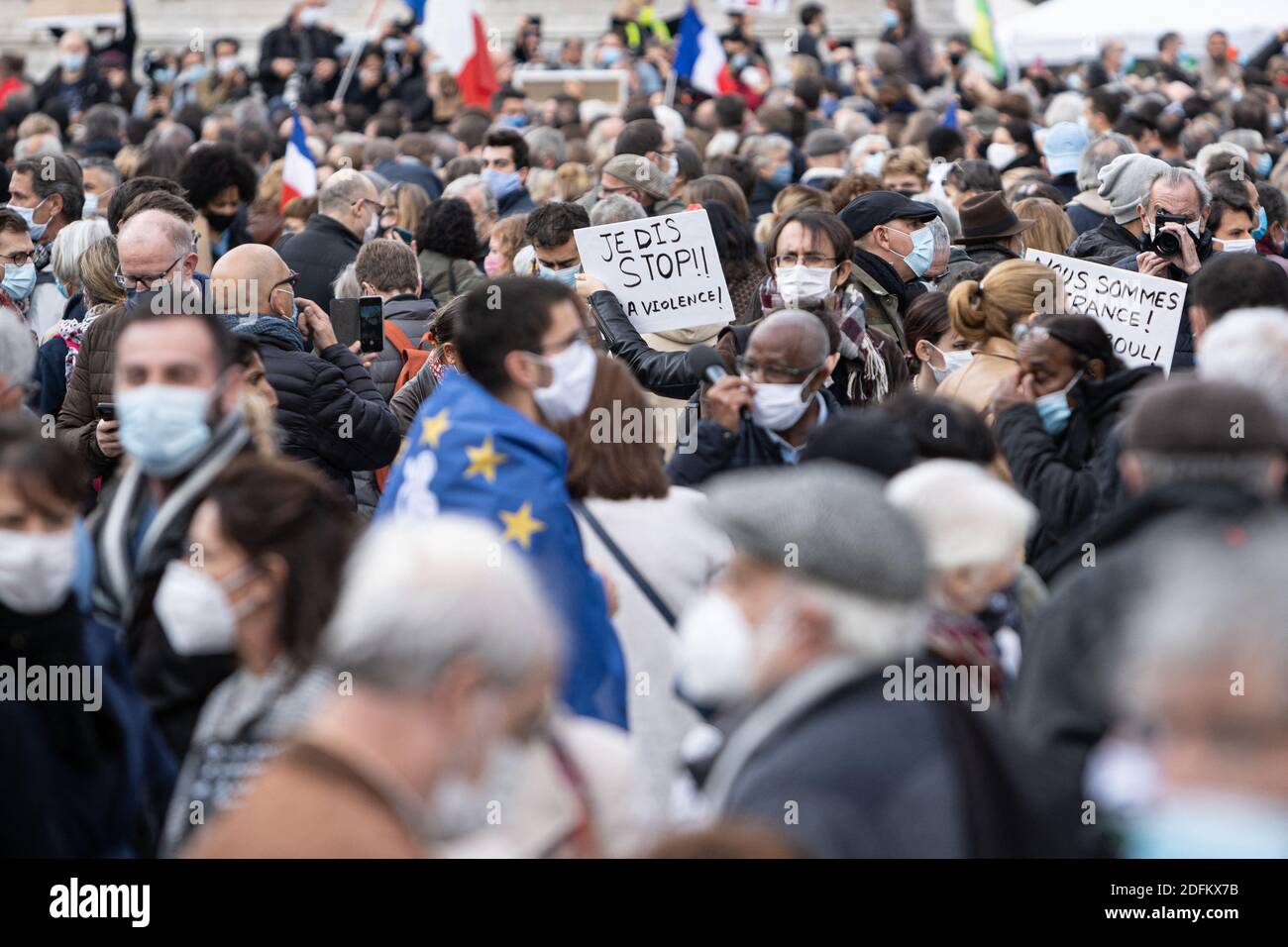 A protester holds a sign saying 'I say stop to violence'. People are demonstrating in Republic Square at the call of Charlie Hebdo and SOS Racism to pay tribute to Professor Samuel Paty, assassinated Friday for showing his students caricatures of Mohammed. Paris, France, October 18, 2020. Photo by Florent Bardos/ABACAPRESS.COM Stock Photo