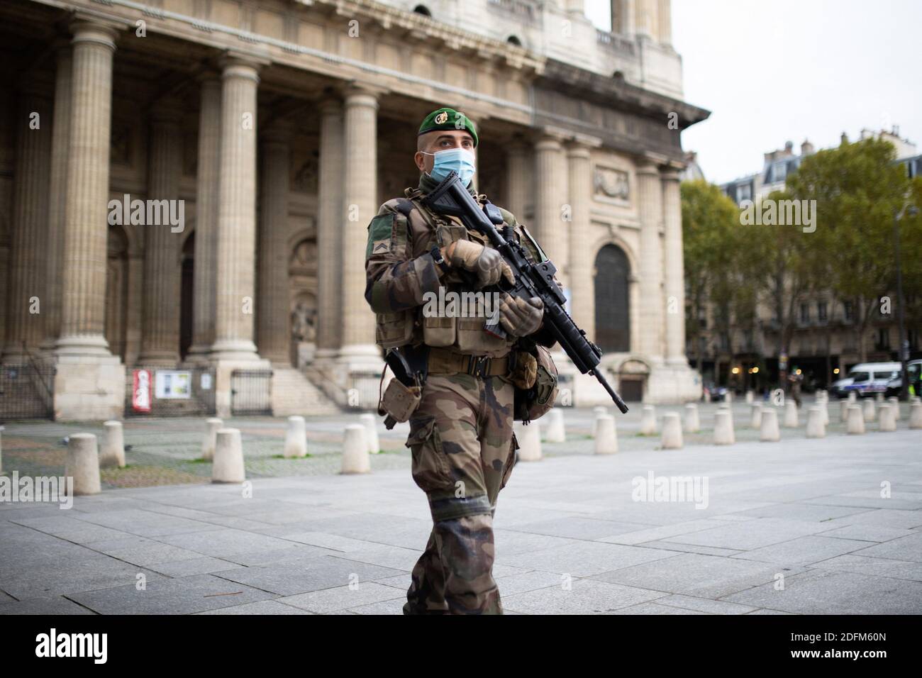 French military forces from the Operation Sentinelle foreign Legion men patrol next to the Saint-Sulpice church area holding a assault rifle in Paris on October 30, 2020, as France placed its terror alert at maximum ahead of the Catholic holiday of All Saints Day, one day after a knife attack in a church of the southern city of Nice. A knife attacker killed three people, cutting the throat of at least one woman, inside a church in Nice on the French Riviera on October 30, 2020. The brutal killings come only two weeks after a French teacher was decapitated outside his school north of Paris by a Stock Photo