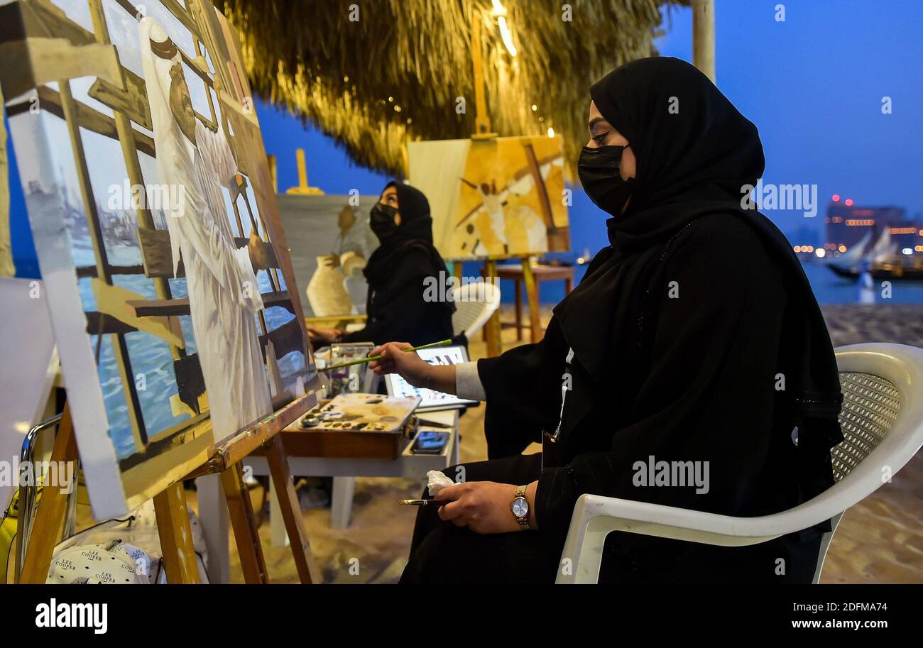 Doha, Qatar. 5th Dec, 2020. A painter works on a painting during the