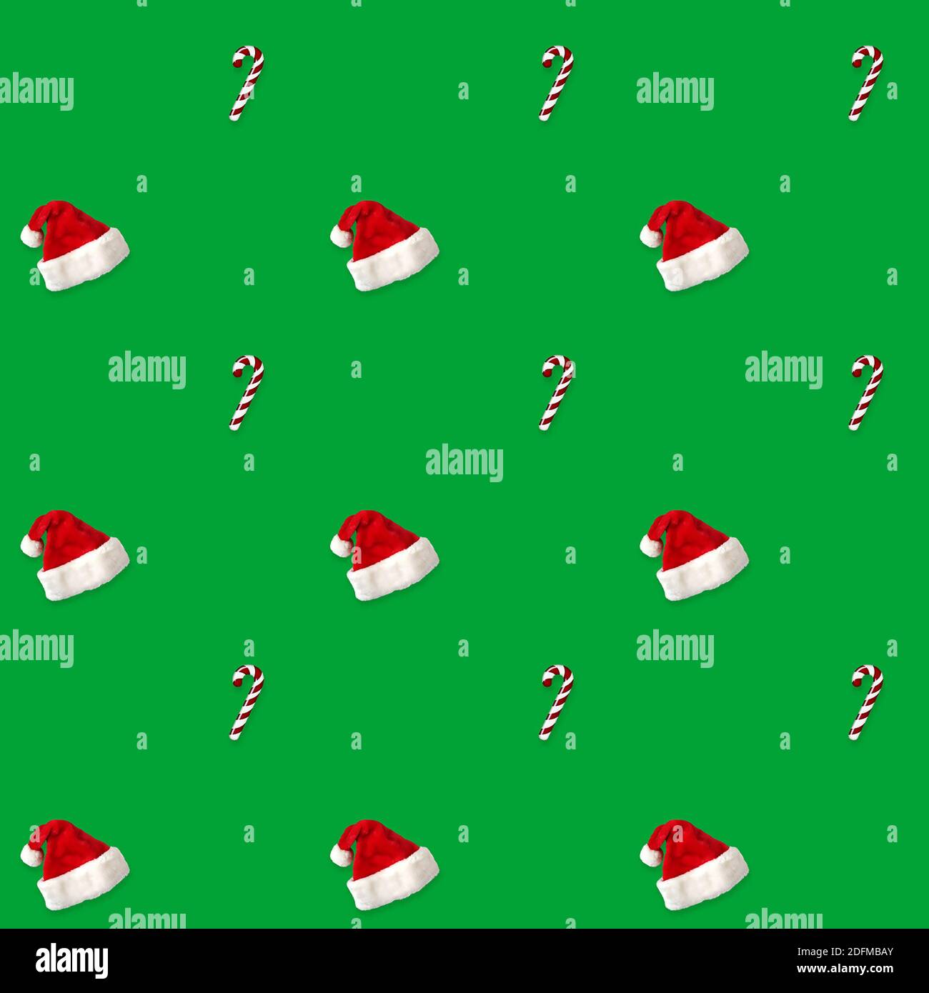 seamless pattern Santa hat and candy cane candy cane on green background Stock Photo