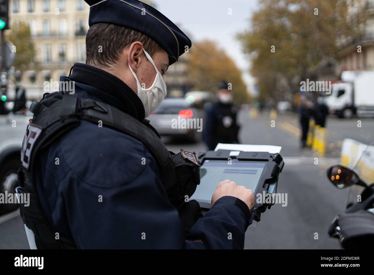 Paris Police Document Police officers check travel documents (attestations de deplacement) on ...