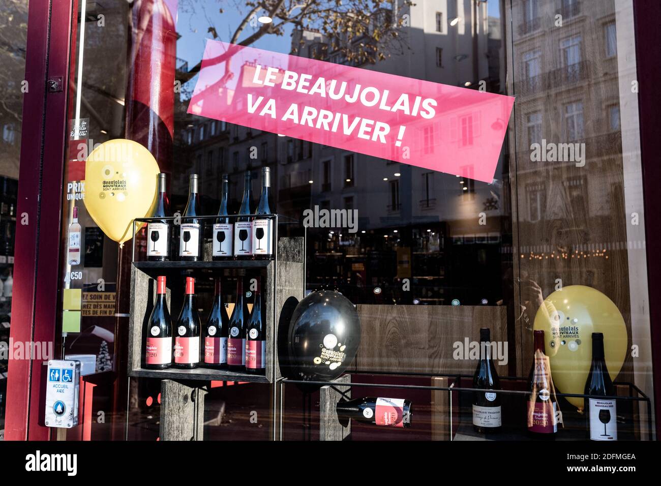 Bottles of Beaujolais Nouveau wine ready for the sale on the eve of the  third thursday of November in the shopwindow of wine seller Nicolas. Paris,  France, November 18th, 2020. Photo by