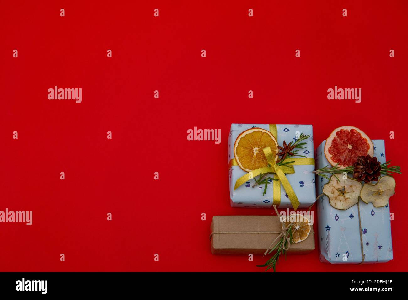 Christmas gifts in corner on red background. Flat lay Stock Photo