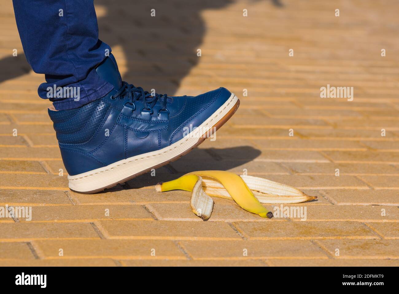 Man stepping on slippery banana skin or peel. About to slide with a banana peel Stock Photo Alamy