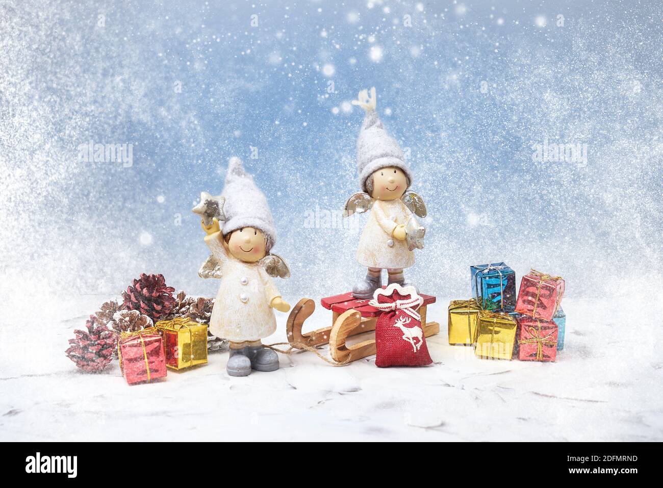 Christmas greeting card. Noel gnomes, small gifts, snow texture. Christmas symbol. Stock Photo