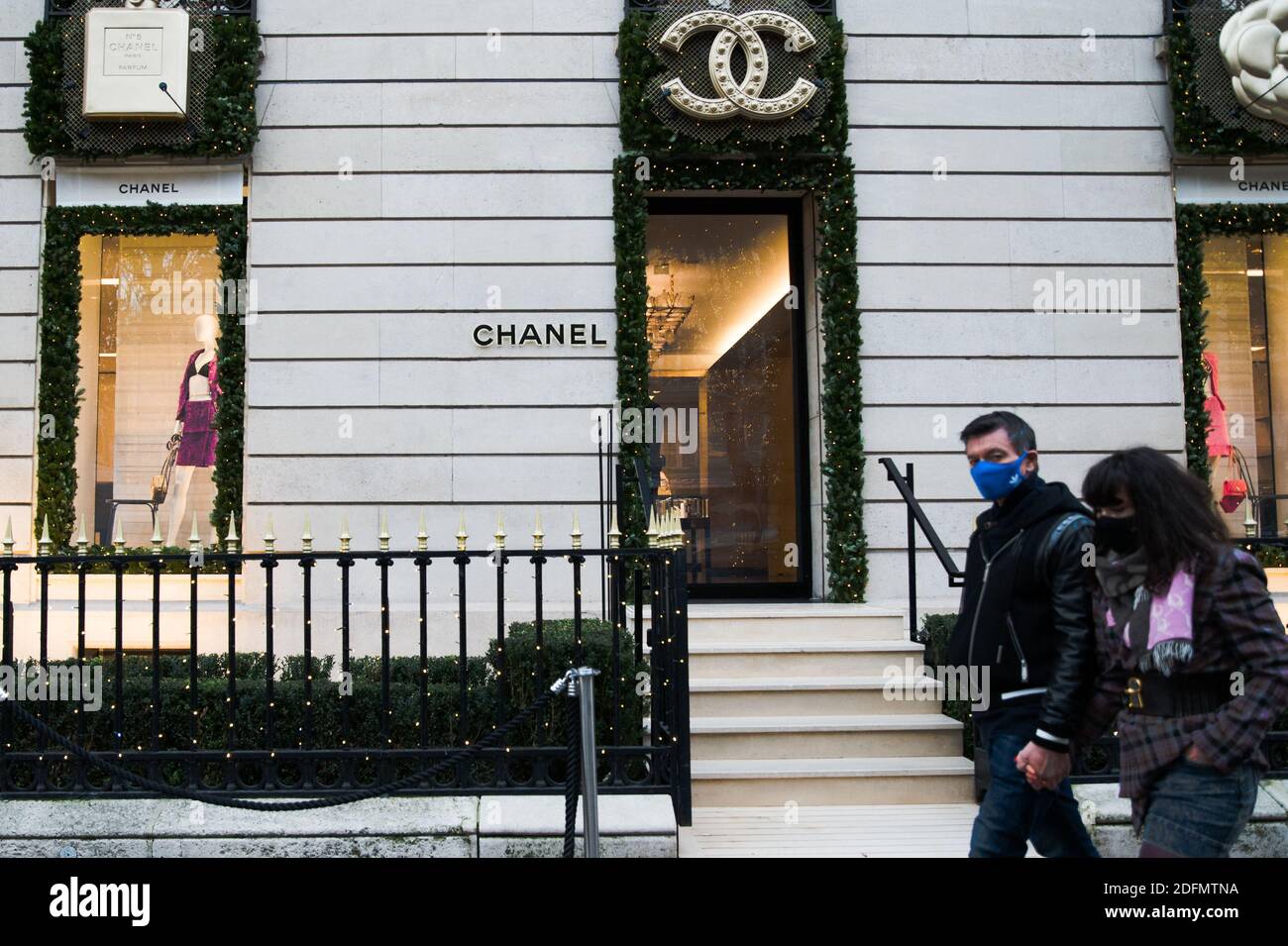 Pedestrians walk in front of a Chanel shop at Avenue Montaigne after French  government eased Covid-19 lockdown measures and allowed all 'non-essential'  shops to re-open in Paris, France, on November 29, 2020.