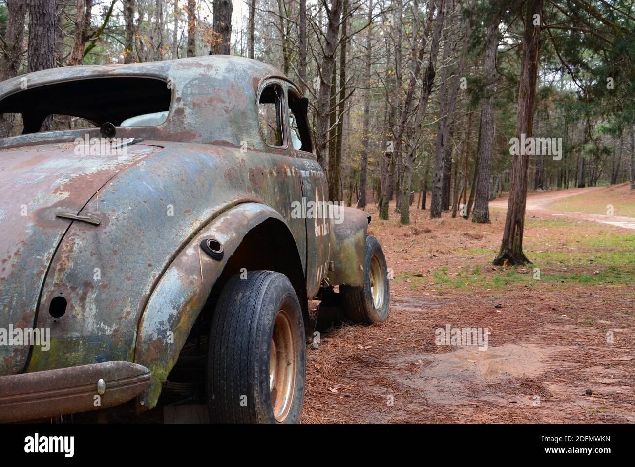 An abandoned vintage race car at the former Occoneechee Speedway, a dirt oval NASCAR track converted to a hiking trail in 2003 Stock Photo