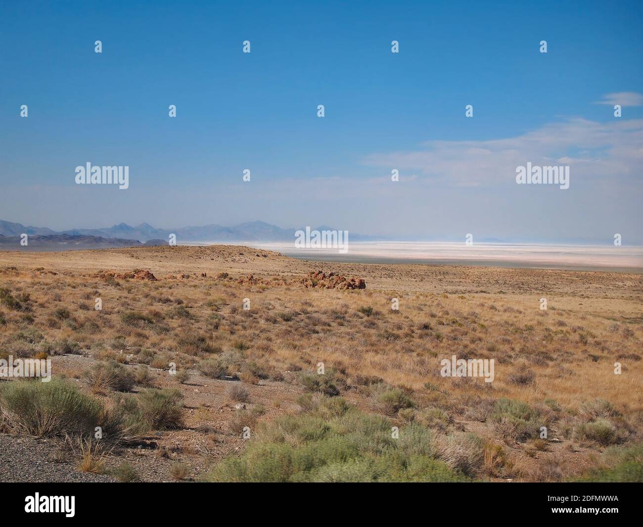 Looking across the arid, sandy, shrubby terrain of eastern Nevada into the Great Salt Lake Desert of western Utah. Stock Photo