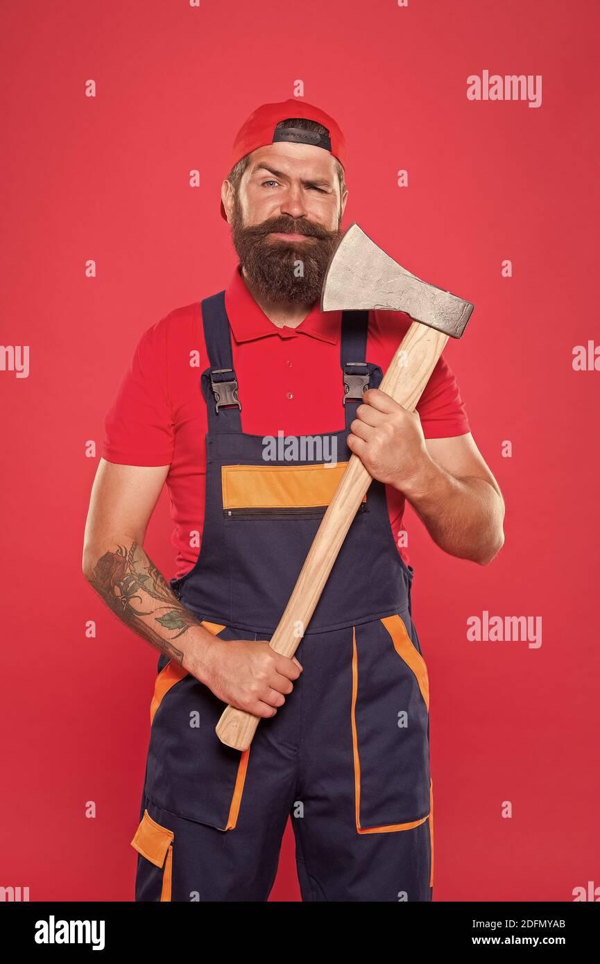 man with axe. forester hold the ax. man in uniform cut beard hair with