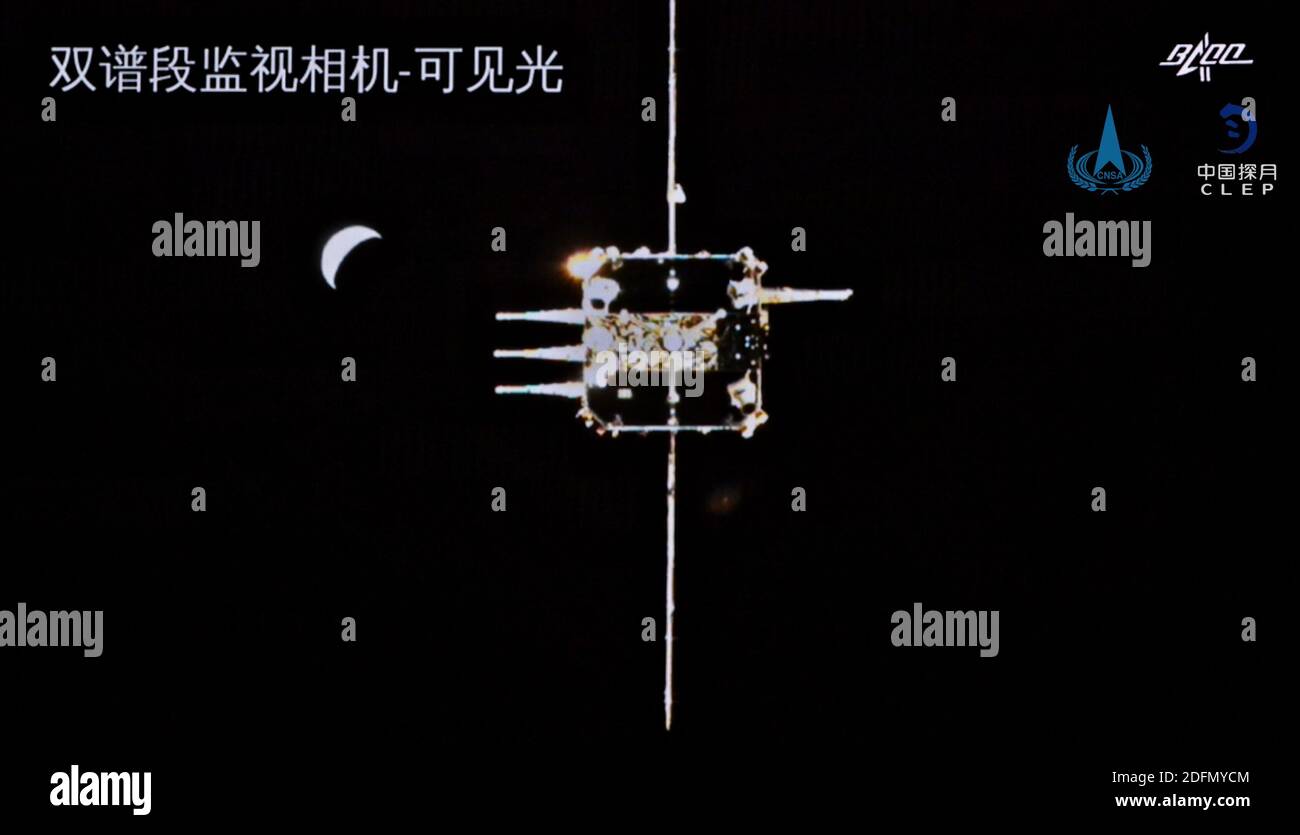(201206) -- BEIJING, Dec. 6, 2020 (Xinhua) -- Image released by the China National Space Administration (CNSA) shows the orbiter-returner combination of China's Chang'e-5 probe approaching the ascender. The ascender of China's Chang'e-5 probe successfully rendezvoused and docked with the orbiter-returner combination in lunar orbit at 5:42 a.m. (Beijing Time) on Dec. 6, 2020, the CNSA has announced. This is the first time Chinese spacecraft have carried out rendezvous and docking in lunar orbit. (CNSA/Handout via Xinhua) Stock Photo