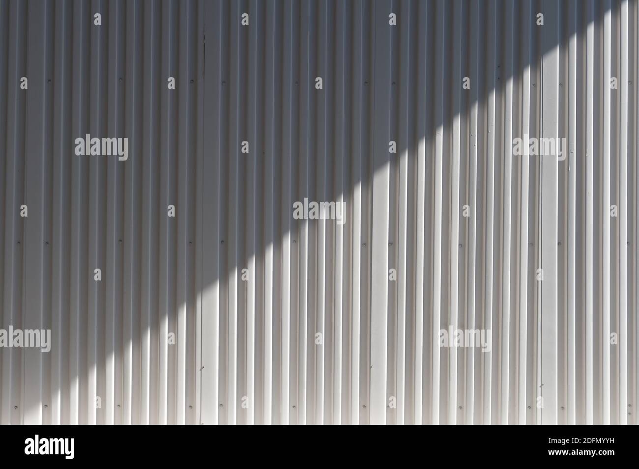 Background and texture of White color corrugated metal sheet with shadow and hilight effect. Stock Photo