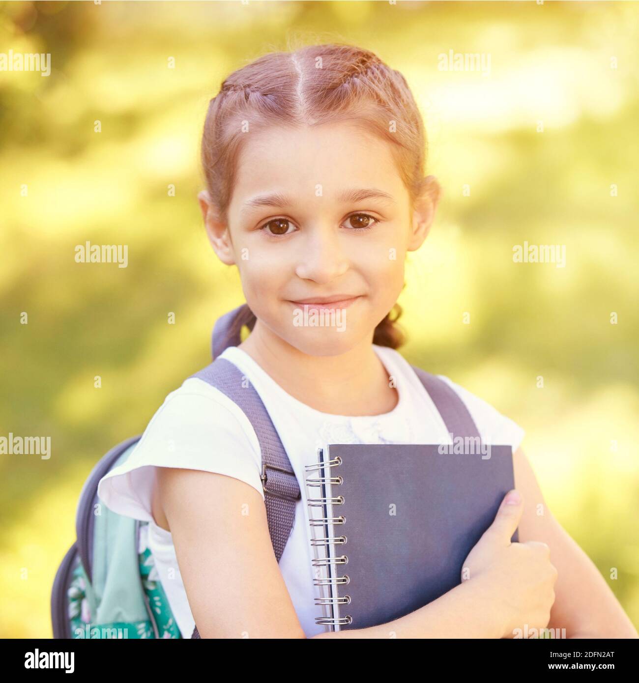 Young pretty girl holding books. School concept Stock Photo - Alamy