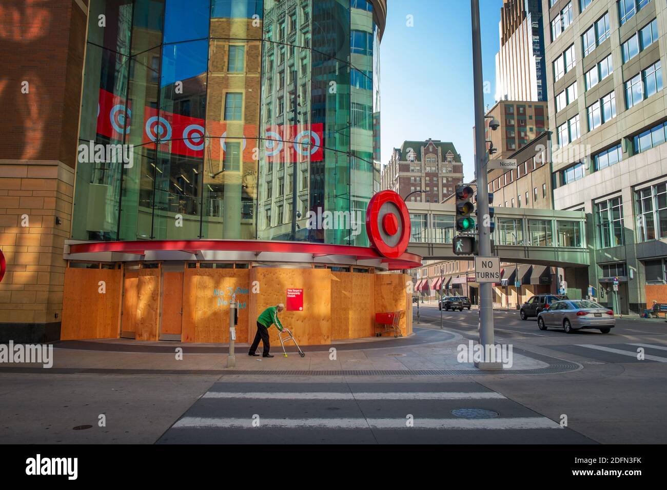 An old man with a walker past a boarded-up Target store in downtown Minneapolis during the BLM protests after the George Floyd murder Stock Photo