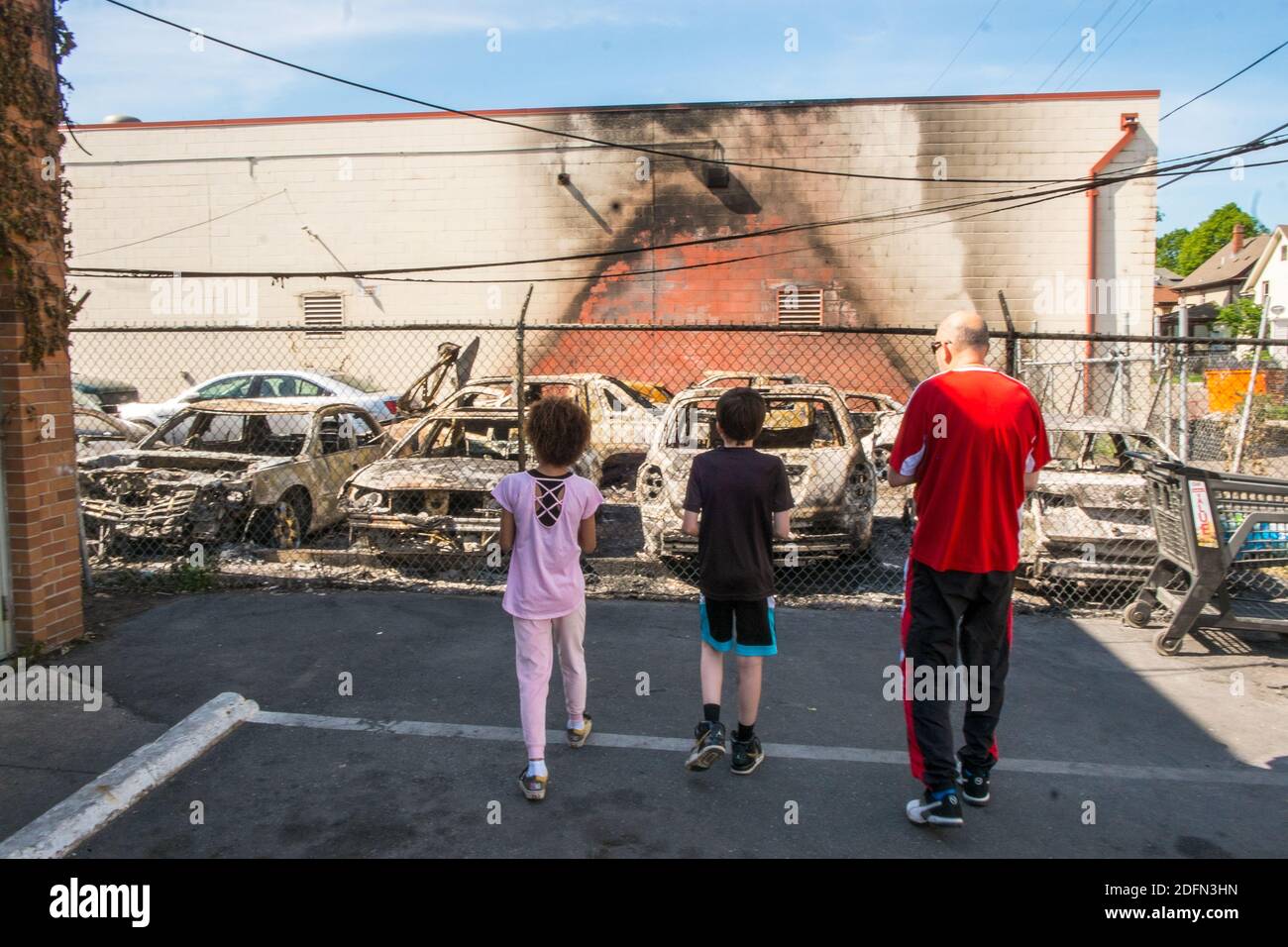 Children look at damage from the aftermath of the Minneapolis riots in June 2020 Stock Photo