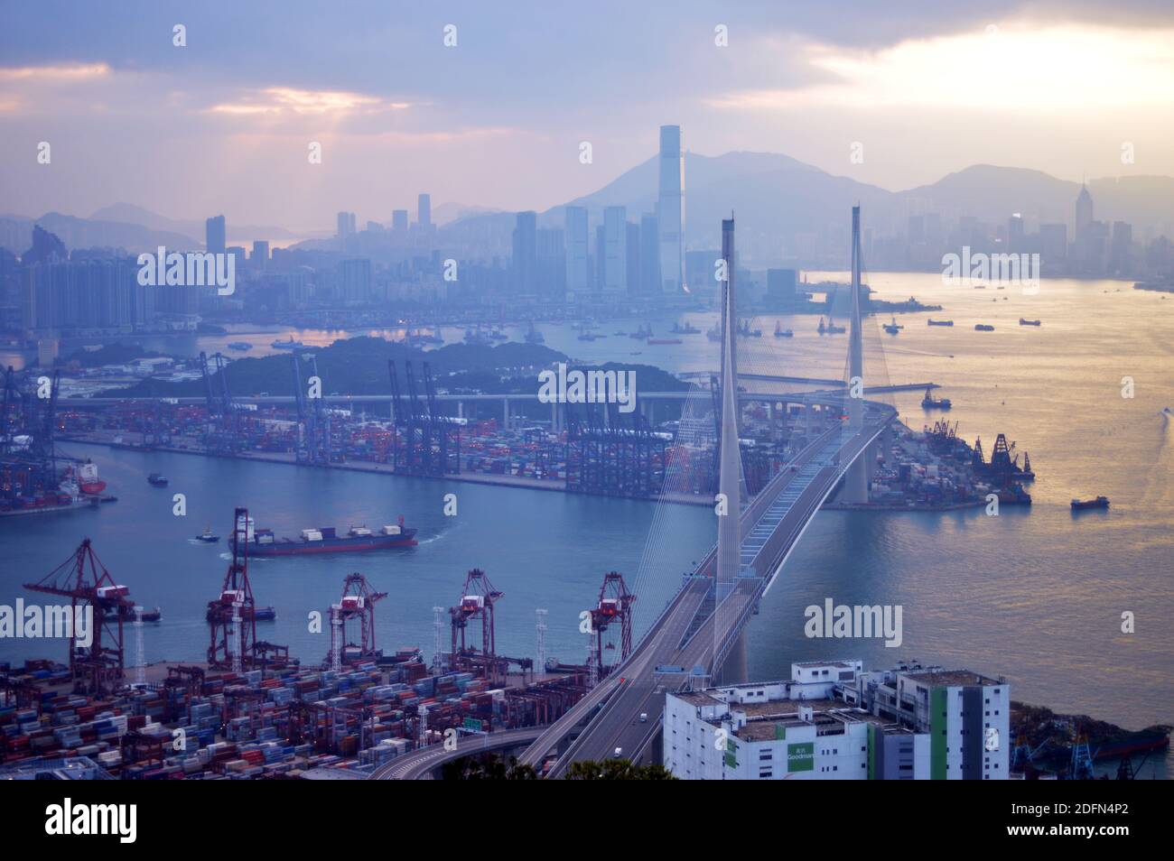 View of Hong Kong cityscape after sunrise (Stonecutters Bridge, Kwai Tsing Container Terminals, and skyline) Stock Photo