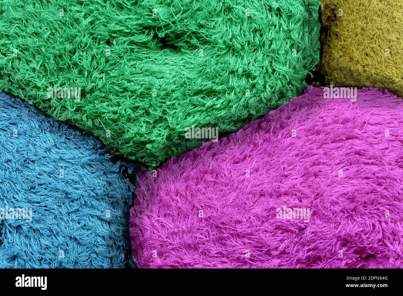 Colored tkan in rolls with a steep plan. Multi-colored rag with a long ...