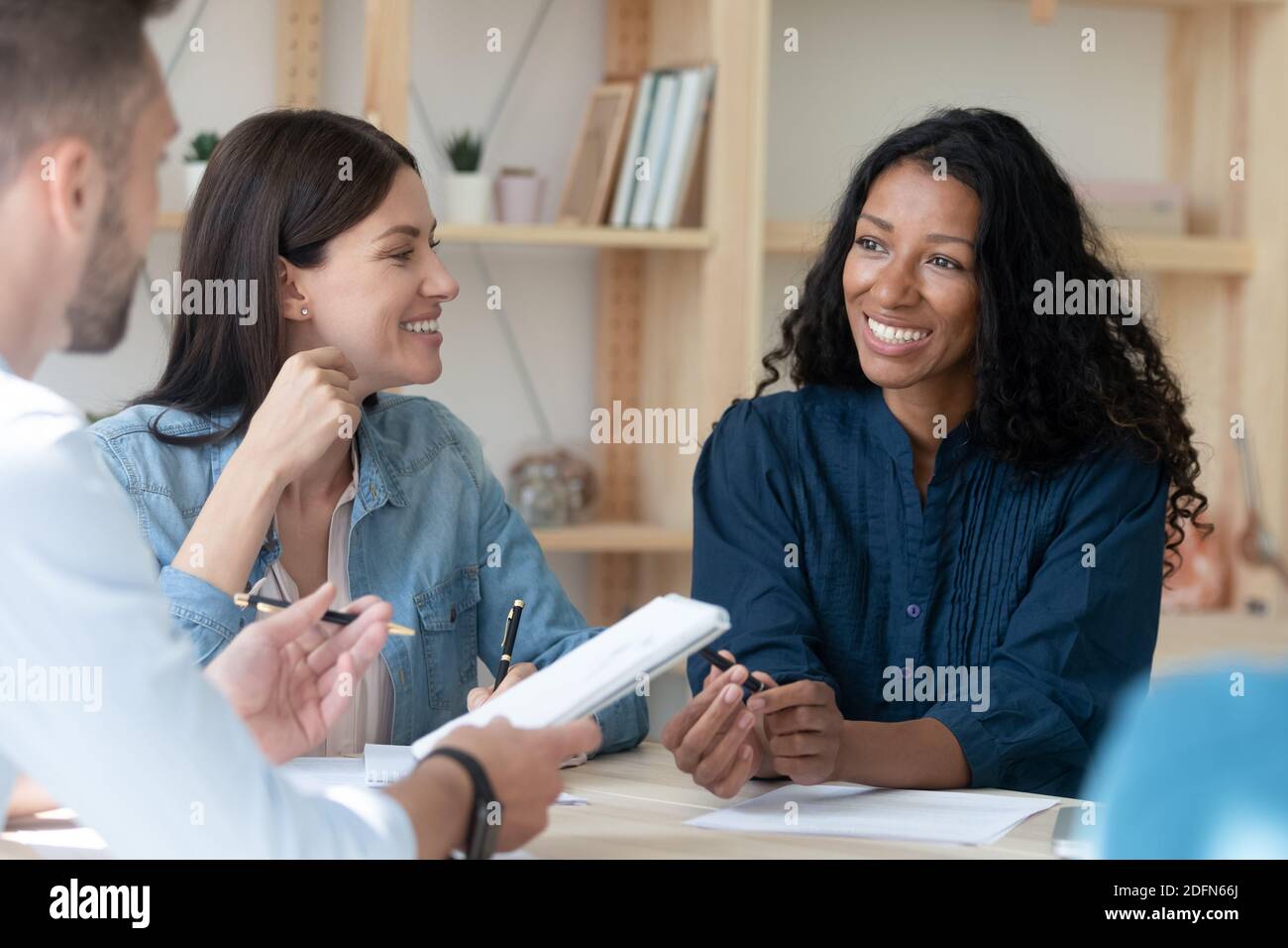 Smiling multiracial employees brainstorm at team office meeting Stock ...