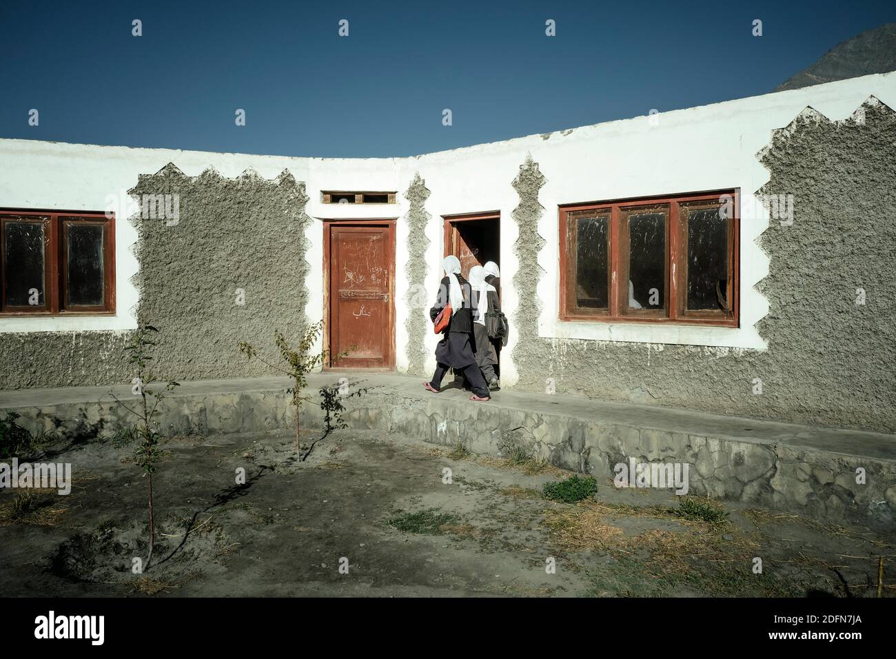 Girls enter school building, village school, Saradh-e-Broghil, Wakhan corridor, Afghanistan Stock Photo