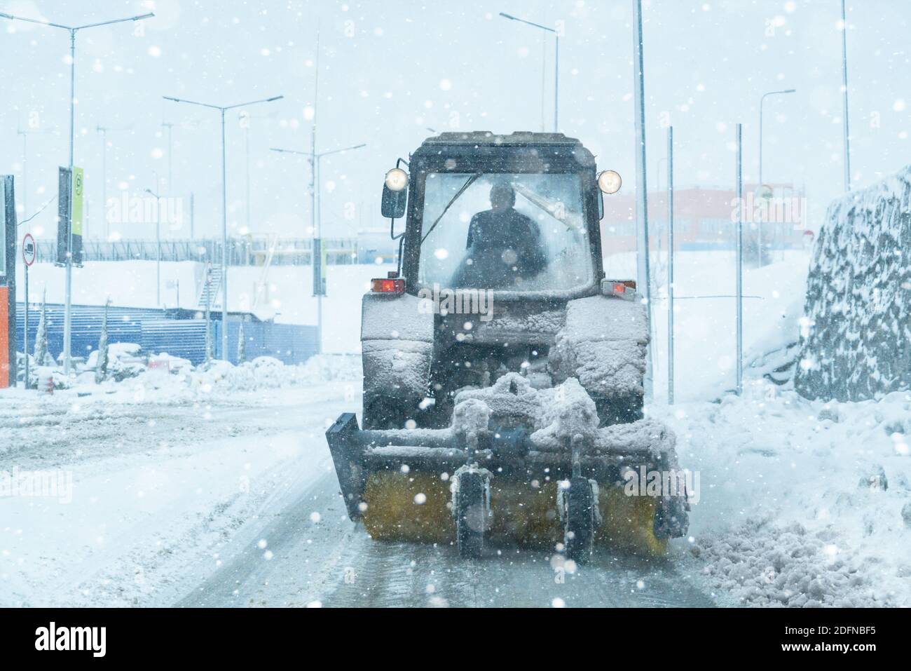 Snow blower removes snow from the sidewalk Stock Photo