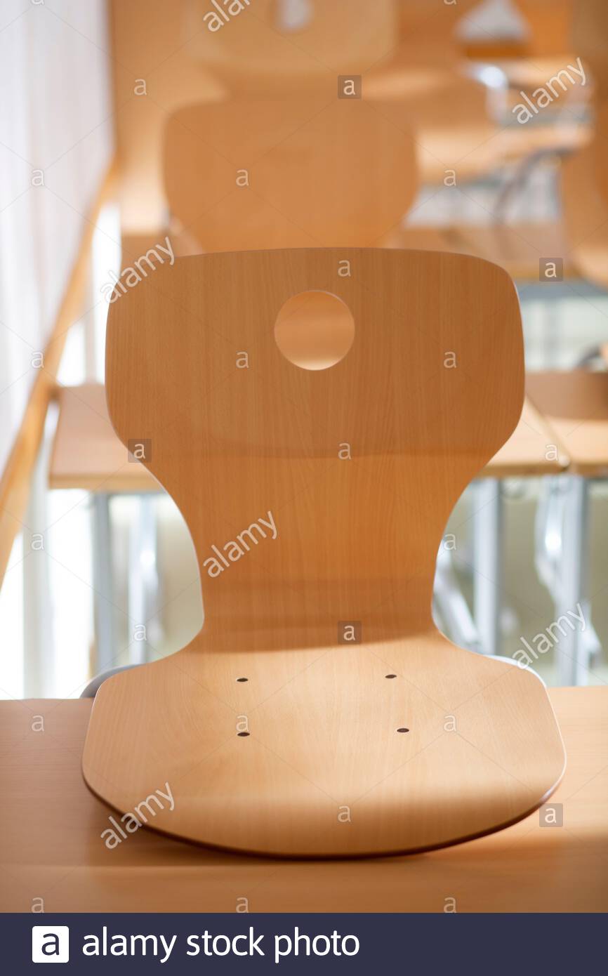 Chairs stacked on school desks in a deserted German classroom as Corona virus figures rise. Stock Photo